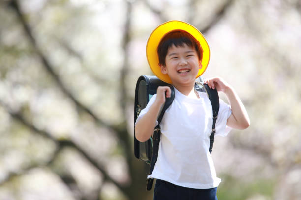 Boy carrying a school bag on his back stock photo