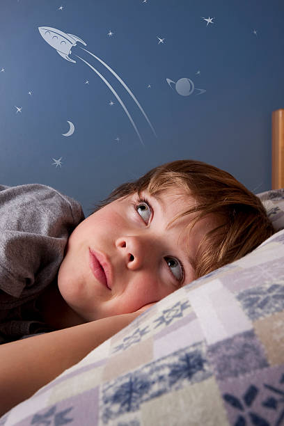 Boy dreaming of rockets and space stock photo