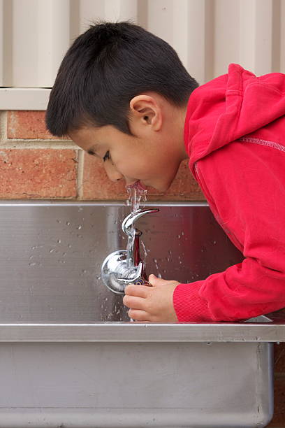 Boy drinking water stock photo
