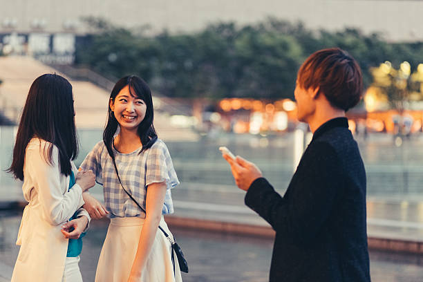 Boy flirting with girls outside Young man talking to unknown girls at the street shy japanese woman stock pictures, royalty-free photos & images