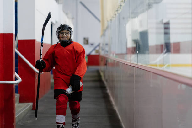 boy getting ready to practice hockey stock photo
