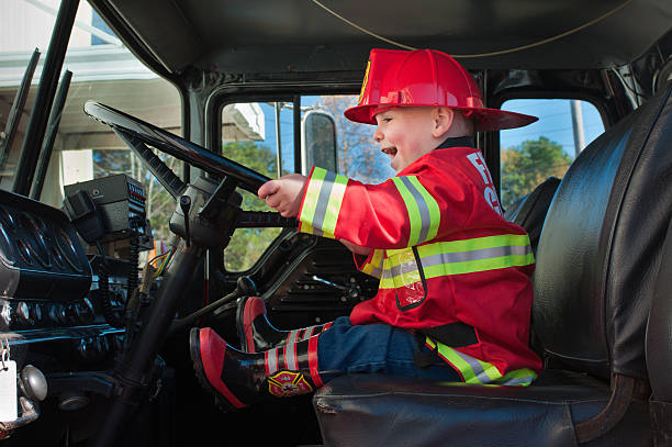 Boy in Fire Truck stock photo