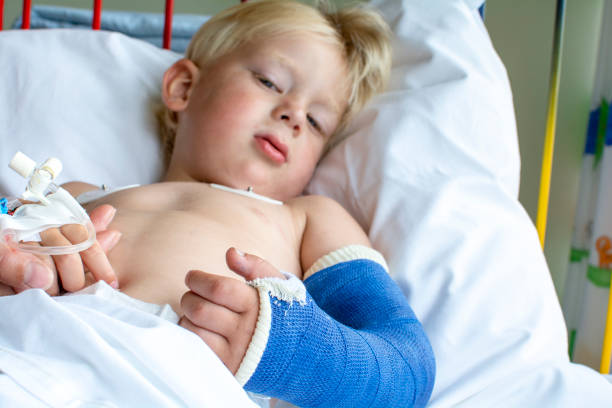 boy in hospital with broken arm stock photo