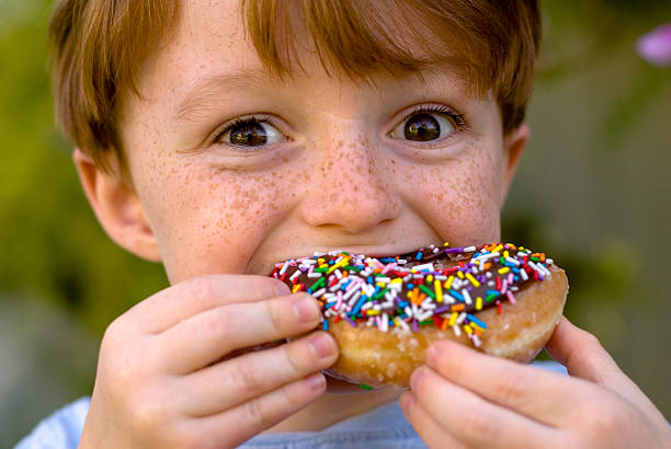 boy-over-eating-chocolate-donut-child-snacking-on-unhealthy-food-picture-id157280534?k=20&m=157280534&s=612x612&w=0&h=J7FDvicXrzL5bycDsUIwwOX6SiRoi9qfd1ZOrDbGOnE=