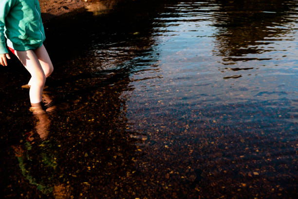 Boy paddling in the water stock photo