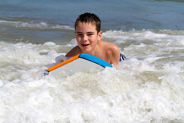 Boy Playing in the Ocean stock photo