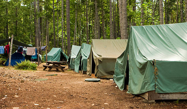 Boy Scout Campground A typical campsite at a Boy Scout Camp includes tents, a table, dirt, and dirty clothes drying on a rope. boy scout camping stock pictures, royalty-free photos & images