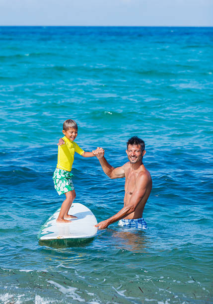 Boy surfing stock photo