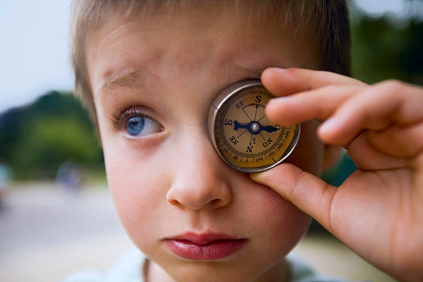 Boy with compass stock photo
