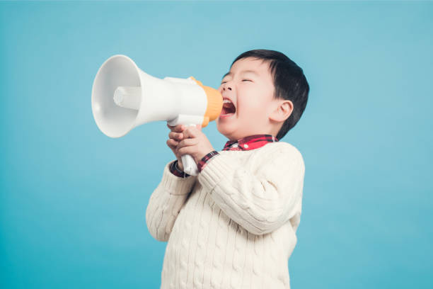 Boy with megaphone making an announcement stock photo