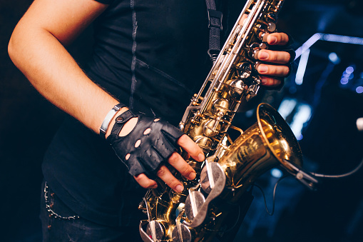 Boys Band saxophone section at event , jazz player male playing on Saxophone, music instrument played by man saxophonist  musician at  folk classical . Alto sax hands Closeup banner