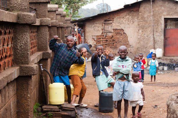Boys Collecting Water in African Slum stock photo