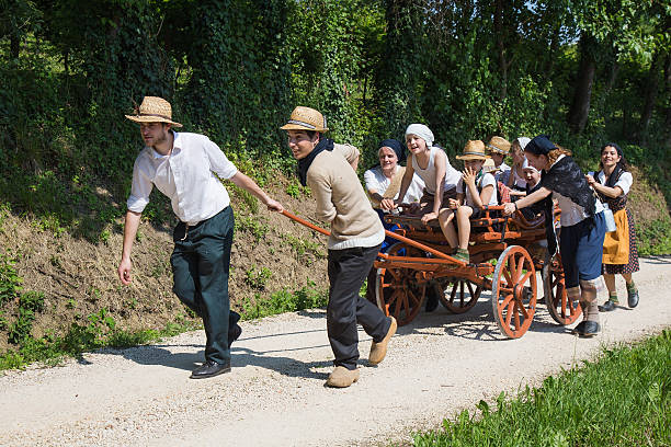 Boys pulled an old farm wagon with group of children. stock photo