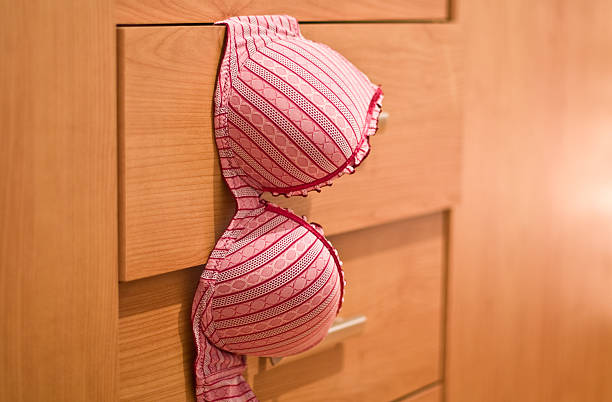 Bra Old red bra hanging from the drawer... shallow depth of field... lepro stock pictures, royalty-free photos & images
