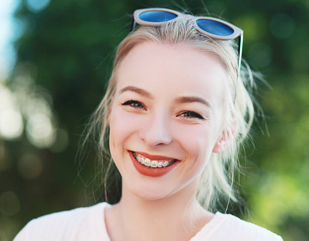 braces on her teeth beautiful blond teen girl with braces on her teeth smiling dental braces stock pictures, royalty-free photos & images