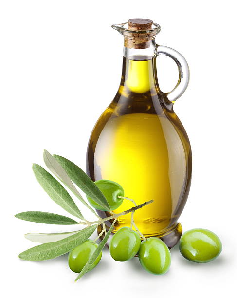 Branch with olives and a bottle of olive oil Branch with olives and a bottle of olive oil isolated on white olive oil stock pictures, royalty-free photos & images