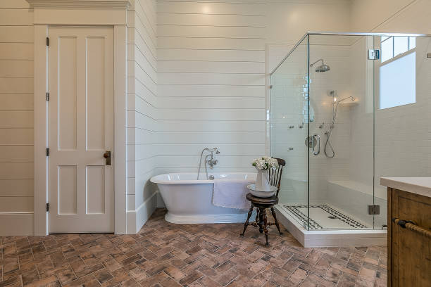 Brand new bathroom suite with antique look and feel Large glass shower and antique look freestanding bathtub bring modern and rustic feel to farmhouse style bathroom shiplap stock pictures, royalty-free photos & images
