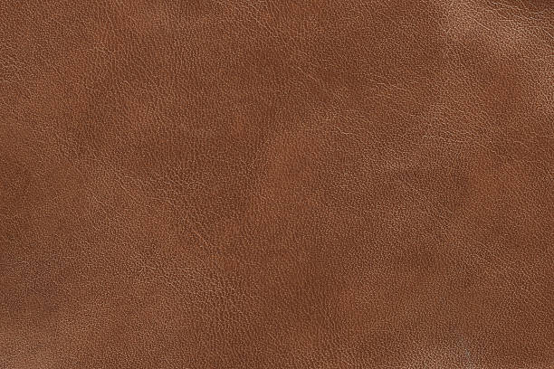Brand new brown leather that looks smooth  Brown leather texture. brown stock pictures, royalty-free photos & images