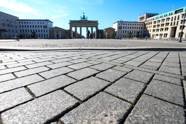 Brandenburg Gate in Berlin, Germany, deserted during Coronavirus shutdown Berlin, Germany - March 24, 2020: Brandenburg Gate in Berlin, usually a major landmark and tourist hotspot, is mostly deserted during Coronavirus lockdown in Germany. central berlin stock pictures, royalty-free photos & images