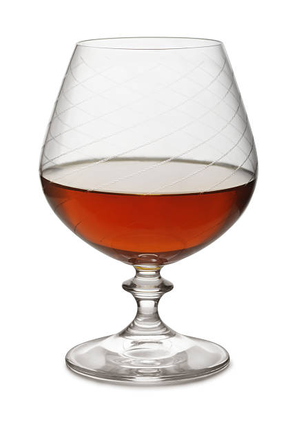 Brandy Snifter of aged brandy isolated on white calvados stock pictures, royalty-free photos & images