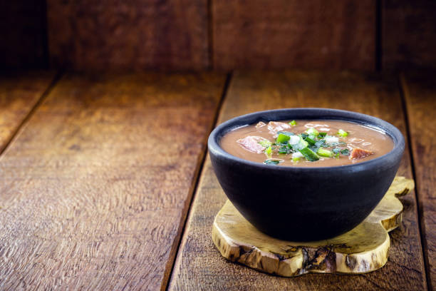 Brazilian bean broth, homemade bean cream served hot, made with stool, pepperoni, vegetables and pepper. stock photo