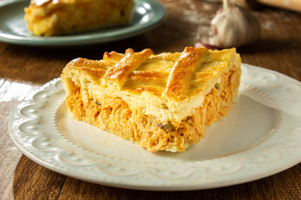 Brazilian Chicken Pie - Homemade Chicken Pie on Spatula on a Wooden Table Rustic Appeal Brazilian Chicken Pie - Homemade Chicken Pie on a Wooden Table Rustic Appeal. meat pie stock pictures, royalty-free photos & images