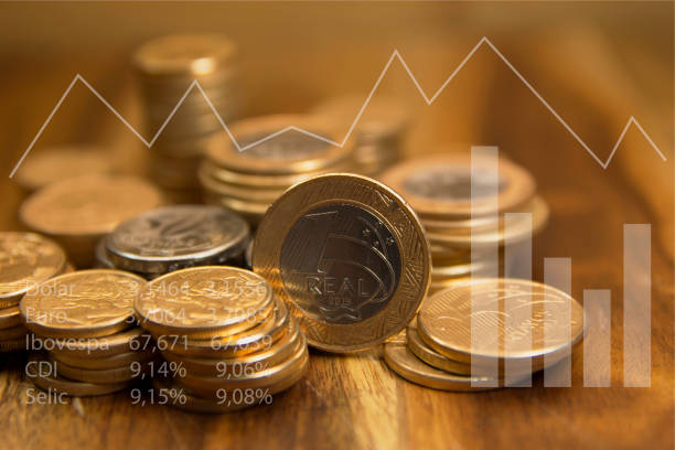 Brazilian coins Brazilian coins and graphics. Economic indicators. Selective focus. inflation economics stock pictures, royalty-free photos & images