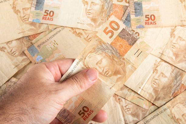 Brazilian money. Hand holding 50 reais banknotes. Brazilian finance concept. stock photo