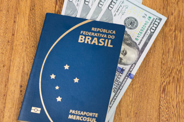 Brazilian passport High resolution image. Brazilian passport (Translation "Brazil Republic federal mercosul passport") and one hundred dollar banknotes wooden background brazil visa for us citizens stock pictures, royalty-free photos & images