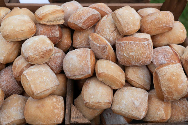 Bread in heaps in a wooden box. Mixed fresh breads. stock photo