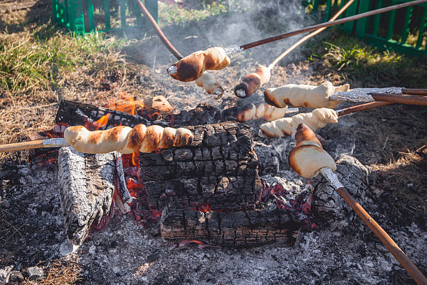 Bread on sticks over an outdoor campfire stock photo
