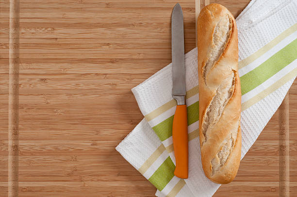 Breads: Baguette/ French Bread/cutting knike stock photo