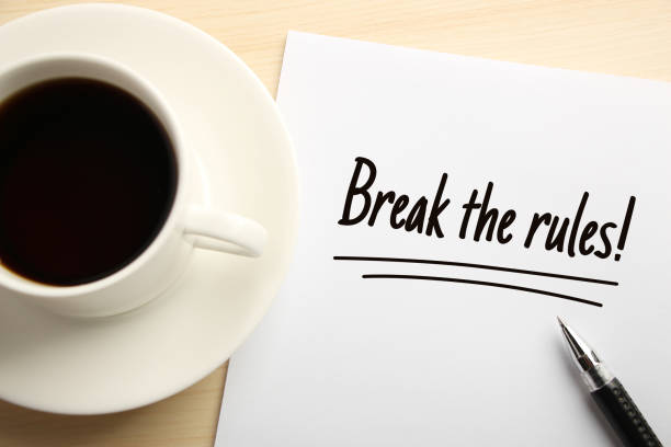 Break The Rules Text Break The Rules written on the white paper with coffee aside. rule breaker stock pictures, royalty-free photos & images