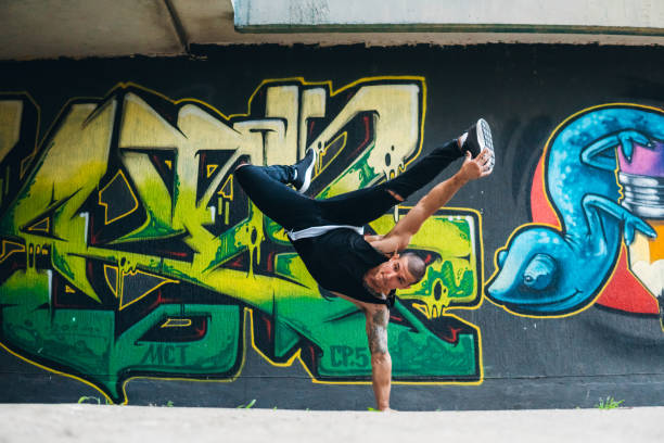 Breakdance Tricks Young Caucasian handsome man performing breakdance tricks. rapper stock pictures, royalty-free photos & images
