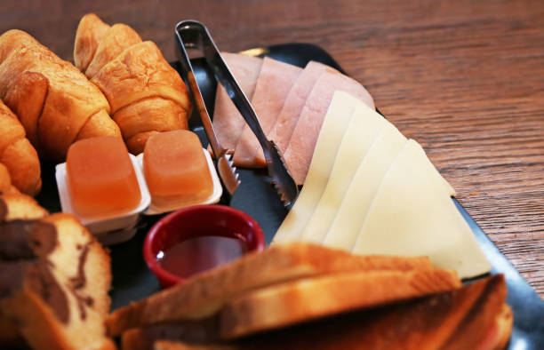 breakfast brunch plate with cold cuts, croissant, cake and marmalade stock photo