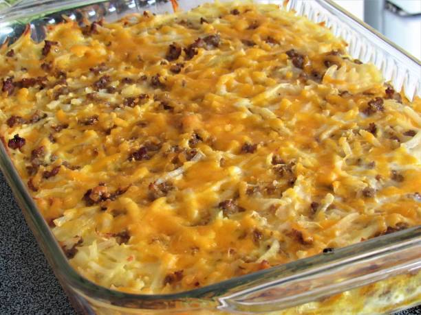 Breakfast Casserole Breakfast casserole in glass baking dish, featuring sausage, cheese, egg and hash browns. hash brown stock pictures, royalty-free photos & images