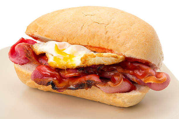 Breakfast egg and bacon roll with tomato ketchup stock photo