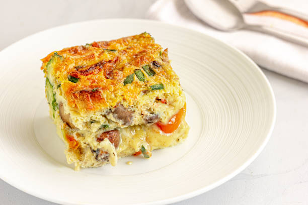 Breakfast Egg Casserole Slice of Breakfast Egg CAsserole on a Plate Close-Up Photo casserole stock pictures, royalty-free photos & images