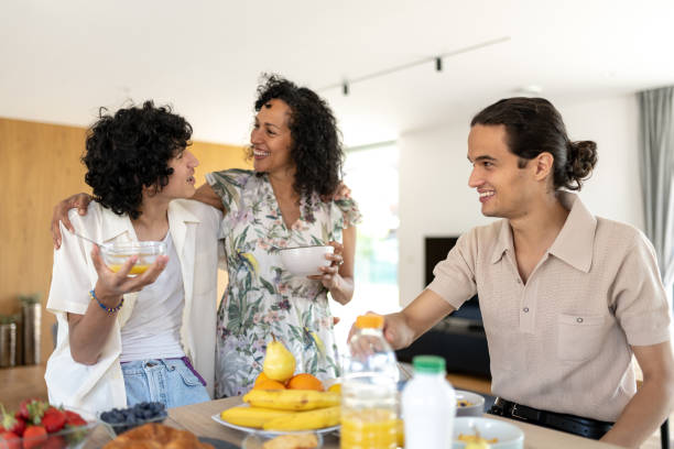 Breakfast of a Latino mother's family with their sons. stock photo