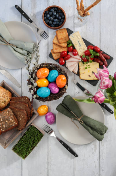 Breakfast table for Easter Sunday celebration with colorful eggs and charcuterie  easter sunday stock pictures, royalty-free photos & images