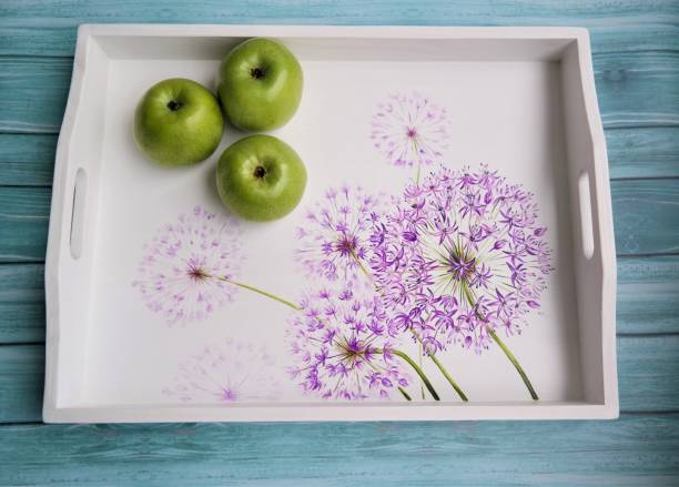 breakfast tray with hand-painted flowers with green apples stock photo