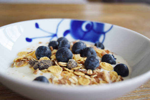 Breakfast yogurt, cereal and blueberries stock photo