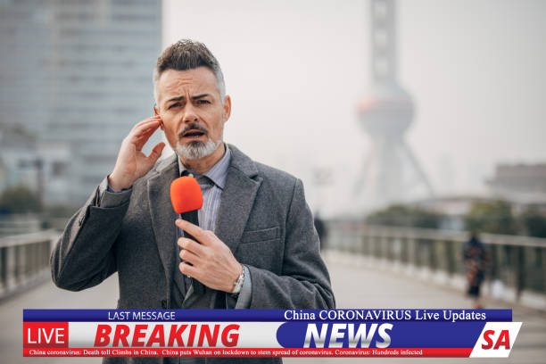 Breaking news reporter reporting on coronavirus from Shanghai One man, handsome breaking news reporter, going live in television program, reporting on coronavirus from Shanghai. breaking news stock pictures, royalty-free photos & images