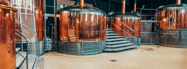 Brewery equipment. Brew manufacturing. Round cooper storage tanks for beer fermentation and maturation stock photo