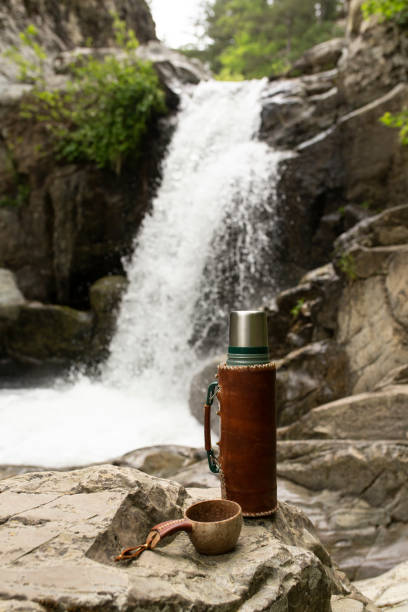 brewing fresh coffee in a hot thermos in the forest stock photo