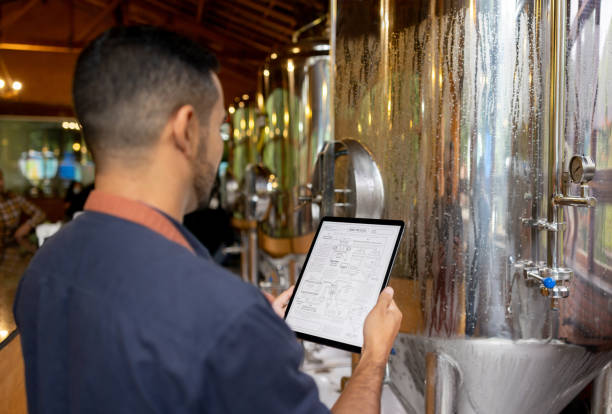 Brewmaster controlling the production line at a brewery stock photo