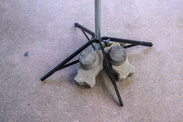 Brick block ballast on umbrella leg for stability. stock photo