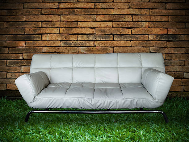 White Sofa Old Brick Wall and New Green Grass