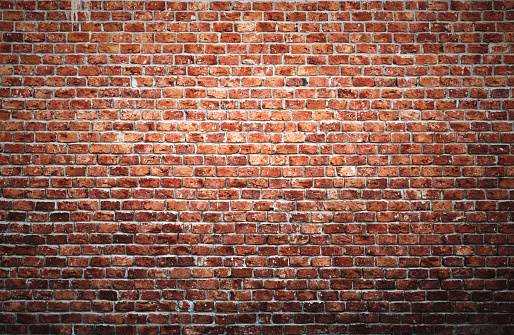 Old brick wall background with vignette effect.