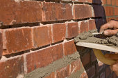istock Bricklayer Repointing Old Bricks 182176654